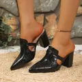 Close-up detail of black textured pointed toe mules with block heel and side cut-outs - 36 / Black