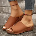 Close-up of brown platform wedge sandals with contrast stitching on outdoor surface - 36 / Brown