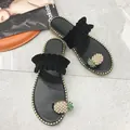 Elegant black flat toe-loop sandals featuring pearl pineapple decor and ruffled strap details - Black Black-Base