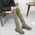 Detailed view of olive green over-the-knee boots with lace-up front and side zipper. - 35 / Green