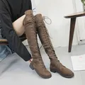 Detailed side view of brown over-the-knee lace-up boots featuring a full-length zipper closure - 35 / Brown
