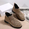 Macro view of leopard print ankle boots with side zipper and chunky lug sole - Leopard Print