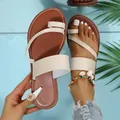Detailed shot of stylish beige toe-loop flat sandals for women with brown soles - 36 / White