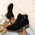Close-up detail of black suede Martin boots featuring buckle strap and low block heel design - 35 / Black