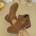 Detail of brown suede ankle boots featuring a buckle strap and elastic side panel. - 35 / Brown