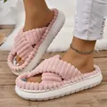 Model wearing pink plush cross-strap platform slippers on a rustic wooden floor - 36-37 / Pink