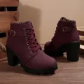 Side detail of burgundy combat boots with a chunky heel and metal buckle accents. - 36 / Burgundy