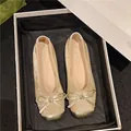 Elegant champagne gold ballet flats featuring a stylish bow and metallic cap toe design - 35 / Apricot
