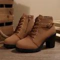 Detail view of brown combat boots with chunky heel and buckle strap - Brown