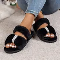 Elegant black faux fur slippers with pearl and rhinestone detail worn on carpet. - 36-37 / Black