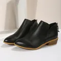 Classic black pointed toe Chelsea ankle boots for women featuring a stylish low block heel - Black