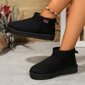 Close-up of black slip-on snow boots with warm lining and stylish red sport label detail. - 36 / Black