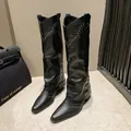 Detailed view of black retro western cowboy boots with gold rivets and pant-leg design - 35 / Black