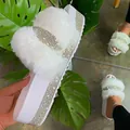 Detailed view of white faux fur platform slides with sparkling rhinestone accents - 35 / White