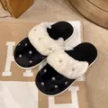 Detail shot of women's warm plush winter slippers featuring sparkling star rhinestone studs - 36-37 / Black