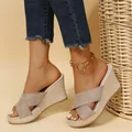 Close-up of stylish women's wedge sandals with straw woven platform and cross straps. - 35 / Off White