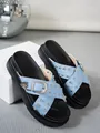 Detailed macro view of women's light blue denim platform slides with silver rivets and buckle - 35 / Sky Blue