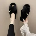 Vue détaillée des chaussons en fausse fourrure noire avec perles et touches dorées - 36-37 / Style Peluche Croisée (&X77) / Noir