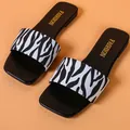 Detailed view of women's fashion square-toe slides with zebra print on peach backdrop - 35 / Black Vertical Stripes