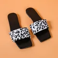 Close-up of women's square-toe slippers featuring a black and white leopard print strap - 35 / Black Spotted Pattern