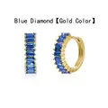 Close-up of golden hoop earrings featuring vibrant blue baguette-cut cubic zirconia. - Gold / Blue