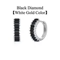Detailed macro view of black baguette-cut zircon hoop earrings in white gold finish - White Gold / Black