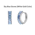 Detailed macro view of baguette-cut sky blue zircon hoop earrings in elegant silver finish - White Gold / Sky Blue