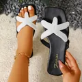 Close-up of black summer sandals featuring a white pearl-beaded starfish decoration. - 35 / Black