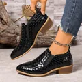 Close-up detail of black checkered pointed-toe loafers featuring a low brown chunky heel - 35 / Black