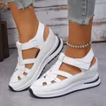 Detailed view of women's white Roman platform sandals with velcro straps and hollow design. - 35 / White