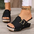 Detailed view of black wedge sandals with metallic buckle and rivet accents - 35 / Black