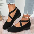 Stylish black pointed-toe wedge shoes featuring crisscross elastic straps worn with jeans - 36 / Black (Elastic Strap Style)