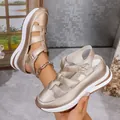 Close-up detail of champagne gold hollow-out wedge sandals with thick platform soles - Gold