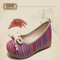 Detailed macro view of women's ethnic striped cloth shoes with red and blue pattern design - 35 / Red