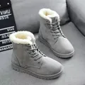 Grey faux fur lined winter snow boots with lace-up design presented on a grey fabric sofa - 36 / Gray