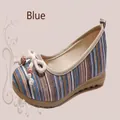 Detailed view of the striped fabric and beaded bow on a traditional blue flat shoe - 35 / Blue