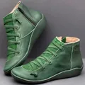 Detailed view of green flat leather Martin boots with decorative laces and side zipper - 35 / Green