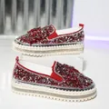 Close-up detail of luxury red rhinestone platform loafers with elegant butterfly bow - Red
