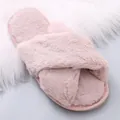 Gros plan de chaussons en peluche rose avec brides croisées et texture douce - Rose Poudré