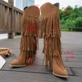 Detailed close-up view of vintage brown suede tassel boots with height and width markings - Brown