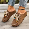 Vintage brown suede Birkenstock-style loafers for women featuring colorful beads and laces - 38 / Camel