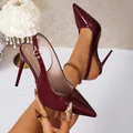 Close-up of elegant burgundy patent leather slingback heels with a sharp pointed toe - 34 / Burgundy