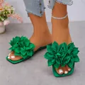 Close-up of green flat sandals with large floral embellishments and square open toe - 35 / Green
