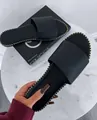 Detail showing the golden stud trim on these black flat slide sandals for women - 35 / Black