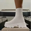 Detailed view of white knitted fly-weave sock boots featuring a chunky lug sole. - 36 / White