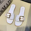 White minimalist flat slide sandals for women featuring a stylish gold buckle accent - 35 / White
