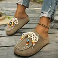 Detail view of ethnic style suede loafers featuring colorful bead accents and laces - 36 / Khaki