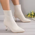 Elegant beige knit ankle boots featuring a pointed toe and stiletto heel, detail side view - Off White