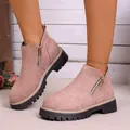 Close-up view of pink suede ankle boots with functional side zipper and lug sole - Pink