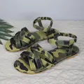 Close-up of women's camouflage flat sandals with elastic ankle straps and crisscross bands - Army Green